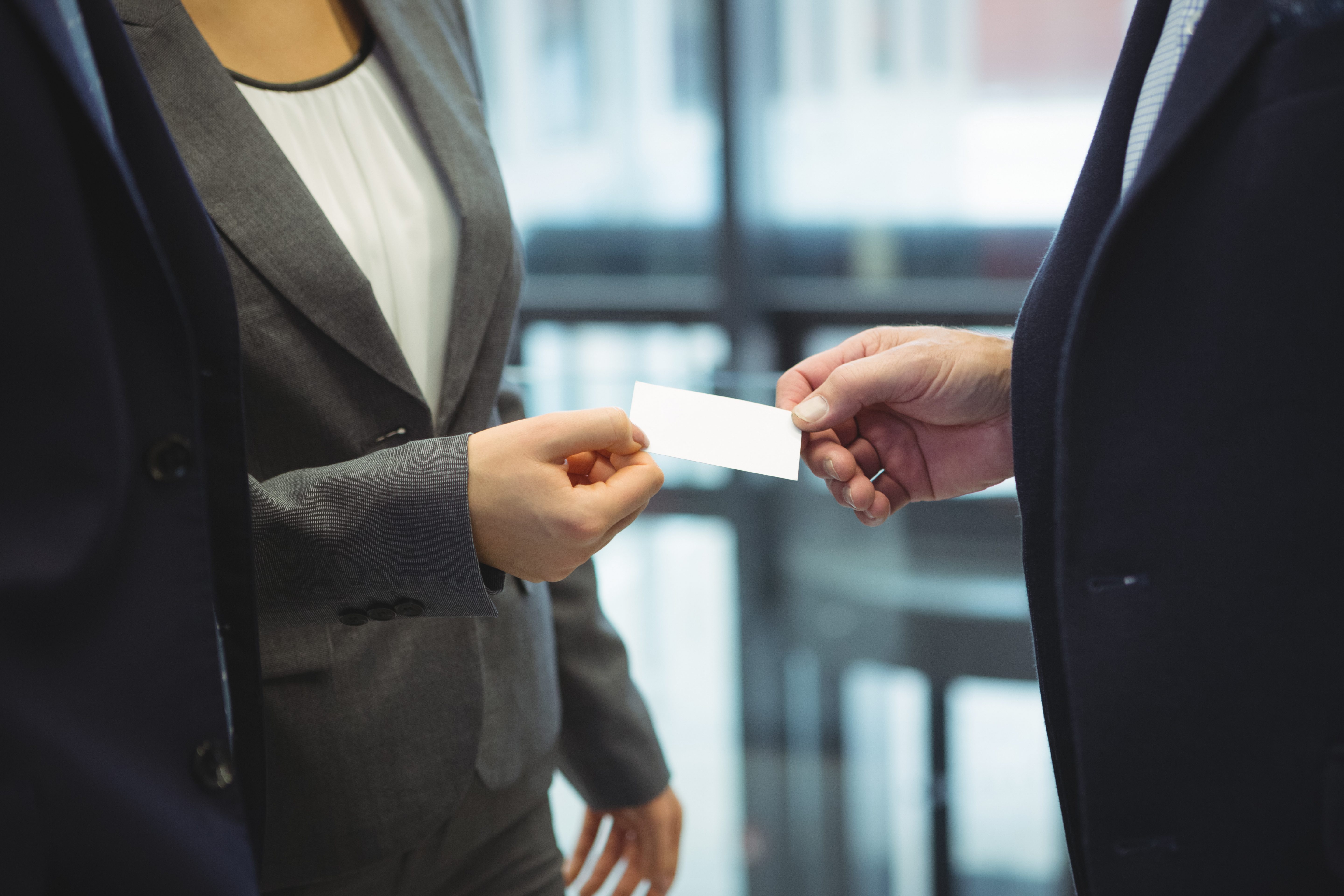 business-executives-giving-business-cards-each-other